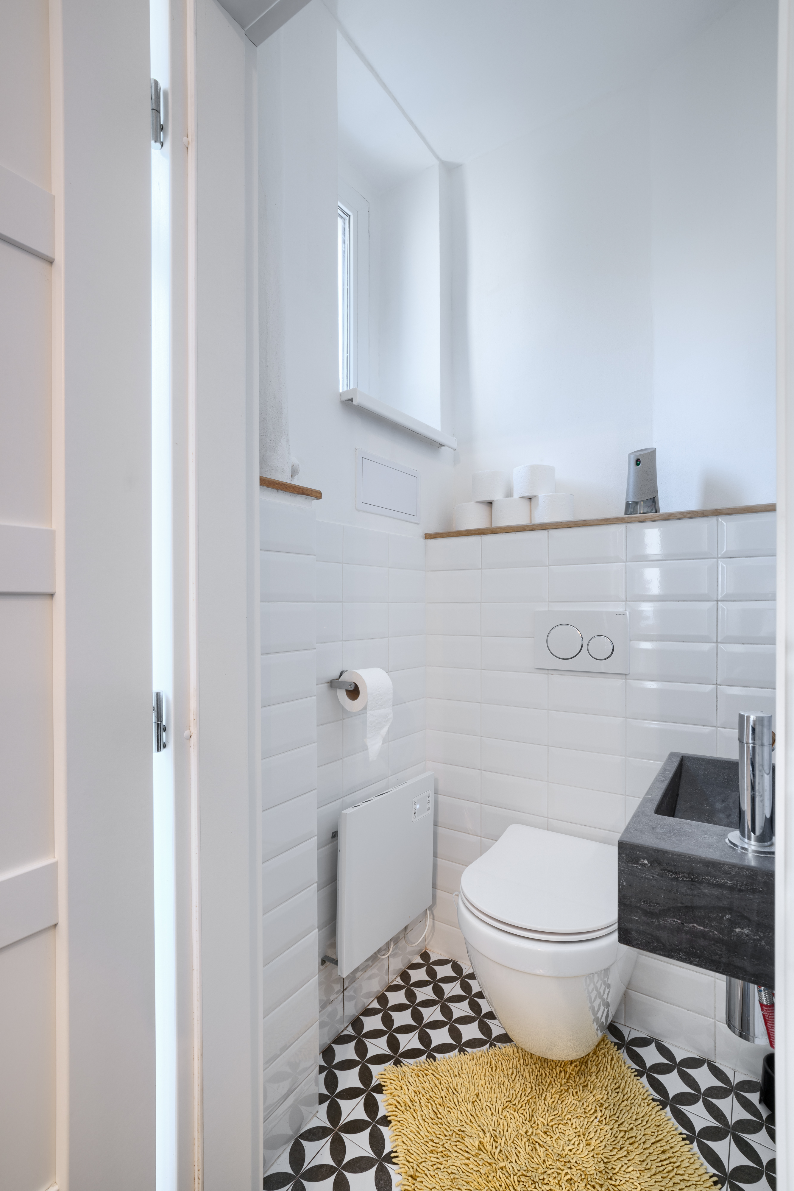 The modern bathroom with its spacious shower and amenities